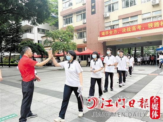 鹤山一中教师与考生一一击掌，为考生加油。