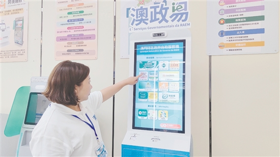 “澳政易”自助服务机整合了社会福利、身份证明、选民登记、市政服务、税务查询、出入境、交通出行等7大类跨境服务。图为工作人员在演示操作流程。