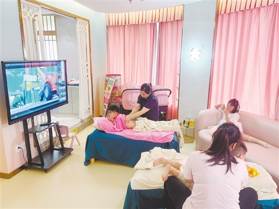 在推拿室里，专业调理师为孩子们进行推拿。