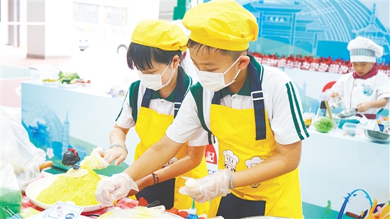学生在烹饪比赛中展现劳动技能。