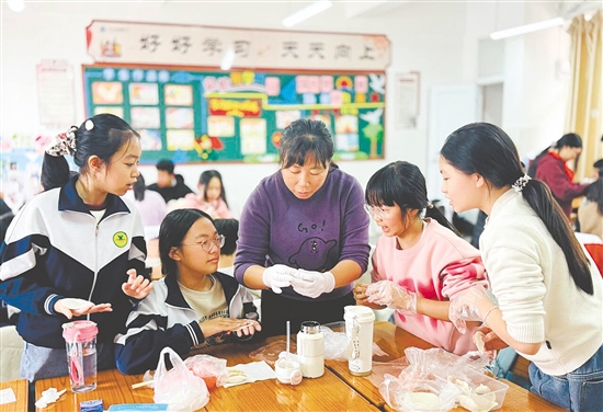 学生在老师的指导下，学包饺子。