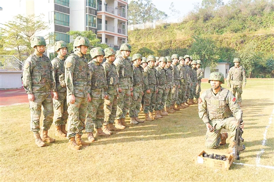 教练员为队员讲解示范武器操作。