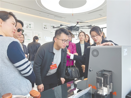 海外侨胞代表在高新江海产业共享展厅参观体验江门企业的创新成果。