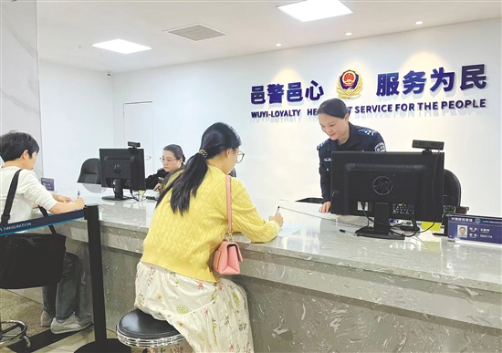 江门市公安局政务服务中心工作人员为群众办证。 江门市公安局政务服务中心工作人员为群众办证。